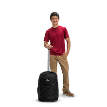 Load image into Gallery viewer, A young man holding the black backpack's telescopic handle.
