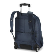 Load image into Gallery viewer, Angled back panel view of the indigo blue backpack. 
