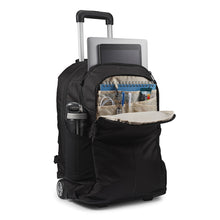 Load image into Gallery viewer, Angled front panel view of the wheeled backpack with stationery, accessories, electronics, and a water bottle organized in the compartments.
