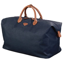 Load image into Gallery viewer, Angled front view of the navy blue duffel bag.
