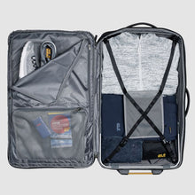 Load image into Gallery viewer, Interior view of the suitcase with clothes and travel goods organized in the compartments. 
