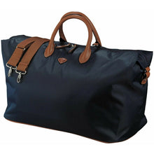 Load image into Gallery viewer, Angled view of the navy blue duffle bag. 
