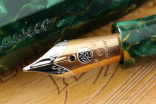 Load image into Gallery viewer, Close up to the fountain pen nib with engraved decorations, Kaweco logo, 14k gold hallmarks, the letter M, and Germany
