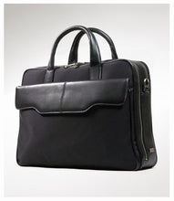 Load image into Gallery viewer, Angled view of the black briefcase on a light gray background. 
