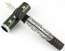 Load image into Gallery viewer, The fountain pen grip section resting on the cap.
