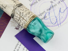 Load image into Gallery viewer, Close up to the engraved edition number and gold ring.
