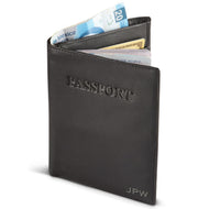 Angled view of the passport cover with cash and credit cards in the compartments. 