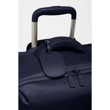Load image into Gallery viewer, Close up to the navy blue suitcase's telescopic handle. 
