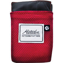 Load image into Gallery viewer, The red blanket folded into its pocket.
