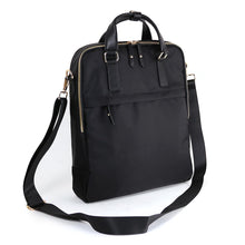 Load image into Gallery viewer, Angled front view of the black backpack backpack with shoulder strap. 
