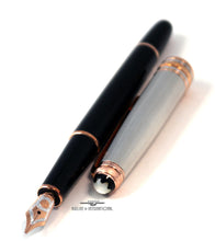 Load image into Gallery viewer, Angled view of the fountain pen with the cap next to it.
