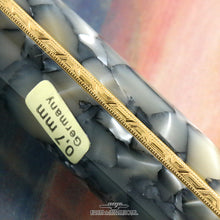 Load image into Gallery viewer, Close up to the pencil's gold band. It has engraved decorations.
