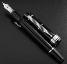 Load image into Gallery viewer, The fountain pen with the cap next to it.
