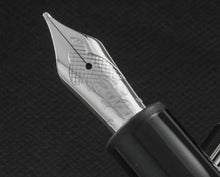 Load image into Gallery viewer, Close up to the fountain pen nib with engraved decorations, a bird, 4810 logo, the Montblanc logo, and 18K gold hallmarks.
