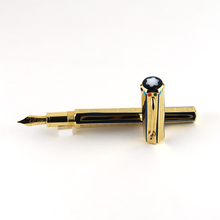 Load image into Gallery viewer, The fountain pen with the cap next to it 
