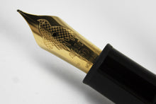 Load image into Gallery viewer, Close up to the golden nib with an engraved dove, 4810 logo, Montblanc logo, and 750 18k gold hallmarks. 
