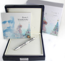 Load image into Gallery viewer, The fountain pen arranged with the packaging and booklet. 
