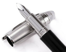 Load image into Gallery viewer, Close up to the pen's grip section resting on the cap.
