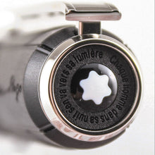 Load image into Gallery viewer, Close up to the pen's top. It features the Montblanc logo and an engraved quote in French.
