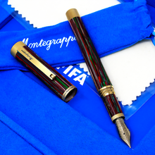 Load image into Gallery viewer, The fountain pen arranged with the cap on the blue interior of the presentation box
