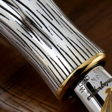 Load image into Gallery viewer, Close up to the pen's grip section and nib engravings.
