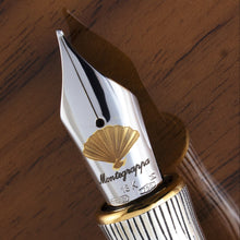 Load image into Gallery viewer, Close up to the fountain pen nib with engraved fan, Montegrappa logo, 18K, M, and gold hallmarks.
