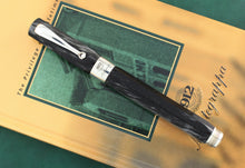 Load image into Gallery viewer, Front view of the rollerball pen with the capon. Set on top of the included book.
