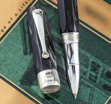 Load image into Gallery viewer, Close up to the cap and grip section of the pen.
