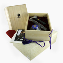 Load image into Gallery viewer, The fountain pen arranged in its presentation box with the included ink bottle, pamphlets, ink eye-dropper, red cloth, and outer box. 
