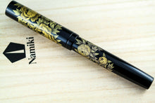 Load image into Gallery viewer, Front view of the fountain pen on the wooden presentation box lid. 
