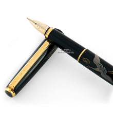 Load image into Gallery viewer, Close up to the pen grip section resting on the cap.
