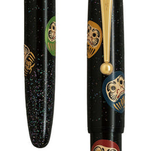 Load image into Gallery viewer, Close up to the Daruma dolls on the pen's barrel and cap.
