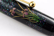 Load image into Gallery viewer, Close up to the flower art and blue shell sprinkled on the cap.
