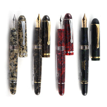 Load image into Gallery viewer, Front view of the four fountain pens with the caps set next to them.
