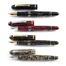 Load image into Gallery viewer, Front view of the four fountain pens arranged with the caps next to them.
