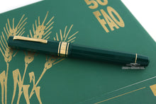 Load image into Gallery viewer, Angled side view of the green fountain pen. 
