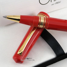Load image into Gallery viewer, Angled close up to the pen's grip section resting on the cap.
