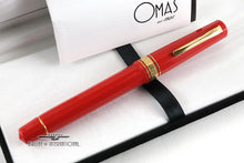 Load image into Gallery viewer, Front view of the red rollerball pen with the included booklet in the presentation box.
