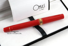 Load image into Gallery viewer, Back view of the red rollerball pen with the presentation box and booklet.
