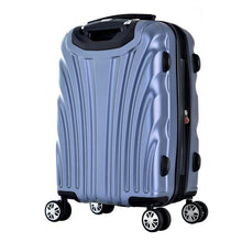 Load image into Gallery viewer, Angled back panel view of the icy blue hard shell suitcase. The side panel has four stub legs to stand on.
