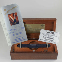 Load image into Gallery viewer, The fountain pen arranged in the pen sleeve with the presentation box, pamphlets and information cards.
