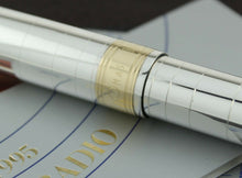 Load image into Gallery viewer, Close up to the golden cap band with engraved OMAS logo.
