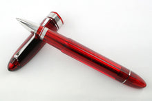 Load image into Gallery viewer, The red rollerball ball pen resting on the cap.
