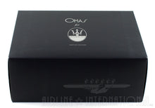 Load image into Gallery viewer, Angled front view of the black outer box with OMAS FOR MASERATI logo on the top.
