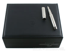 Load image into Gallery viewer, The fountain pen and cap arranged on top of the presentation box. 
