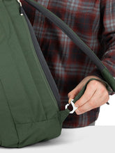 Load image into Gallery viewer, A hand holding the adjustable shoulder strap clip.
