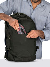 Load image into Gallery viewer, A man placing a leash inside the black backpack's front pocket.
