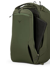 Load image into Gallery viewer, Front panel close up to the green backpack with a laptop peeking from the compartment.
