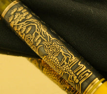 Load image into Gallery viewer, Close up to the dragon design on the pen barrel. 
