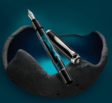Load image into Gallery viewer, The fountain pen and cap arranged on a graphic with a gray and blue stone bowl.
